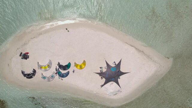 Aerial view of kitesurfing gear and a star-shaped canopy on the white sandy beach of Los Roques, Dependencias Federale, Venezuela.
