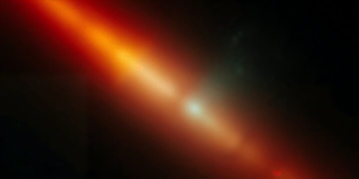 Abstract orange light streak with lens flare effect on dark background