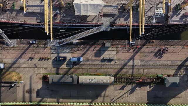 Top down view rising from the museum quay with old railway wagons to the deck of the four-masted barque Peking in Hamburg, Germany, long shadows in low sunlight
