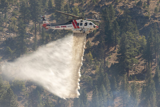 MILFORD CALIFORNIA SEPTEMBER 24, 2026 A CALFIRE Sikorsky S-70 Firehawk helicopter drops water on the Grade Fire near Milford, California.
