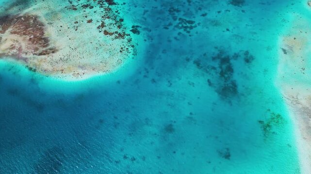 Aerial view of the turquoise waters and coral reefs of the Los Roques archipelago with white sand beaches in Los Roques, Dependencias Federales, Venezuela.
