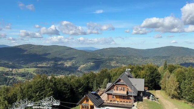 Wooden mountain shelter and chairlift on Mosorny Gron mountain top in Zawoja, Poland.