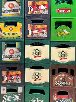 Stacked plastic beer crates with visible Czech brewery logos, arranged in rows for bottle storage, retail distribution and beverage logistics. PRAGUE - September 27, 2026.