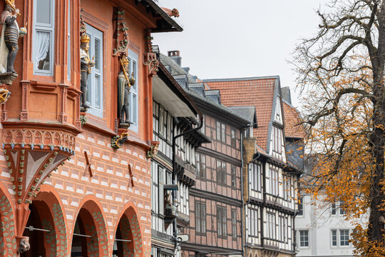 Historic Goslar street features ornate half timbered houses, slate roofs and decorative facades. Traditional German architecture creates charming medieval atmosphere with heritage and travel appeal