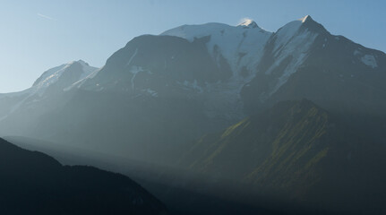 Obraz premium Summer view of the Mont Blanc massif above forested slopes 