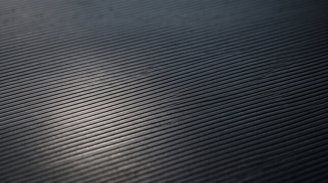 Abstract dark background with parallel lines and soft light reflection