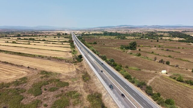 Aerial view of Trakiya Highway stretching across vast agricultural fields and rural landscape in Bulgaria.