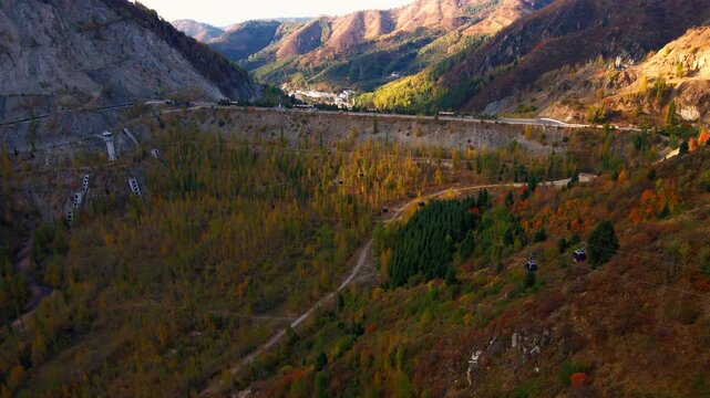 Cinematic view of the cable car connecting Medeu and Shymbulak in Almaty, Kazakhstan, surrounded by the dramatic Tien Shan mountains and scenic alpine landscape.