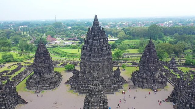 Aerial view of the historic Prambanan Temple complex with ancient stone spires and lush green gardens in Kecamatan Prambanan, Daerah Istimewa Yogya, Indonesia.