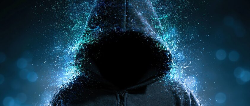 Hooded anonymous figure with digital particles and glow effect on a dark blue mystery background