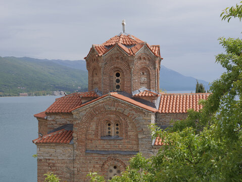 View of the historic Church of St. John at Kaneo with its brick and stone architecture and terracotta roof tiles overlooking Lake Ohrid in Ohrid, Municipality of Ohrid, North Macedonia.
