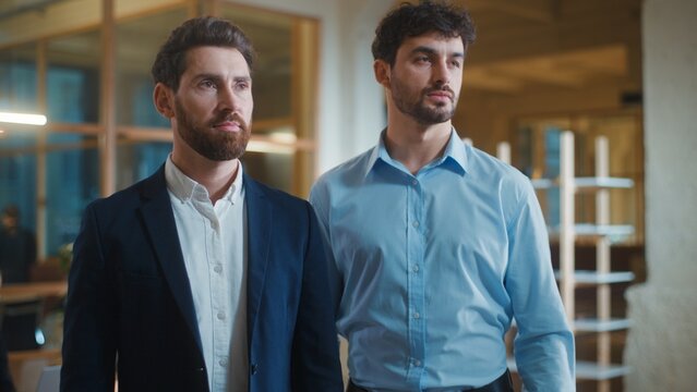 Two pensive Caucasian business men look away thinking looking for solution decision serious confident businessmen startup colleagues professionals think pondering work in corporate agency together