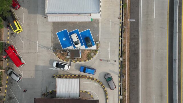 Aerial view of electric vehicle charging station with parked cars and charging bays in Salatiga, Central Java, Indonesia.