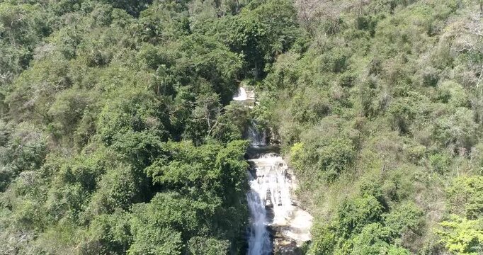 Aerial view of a cascading waterfall surrounded by dense tropical forest in Henri Pittier National Park near Maracay, Aragua, Venezuela.