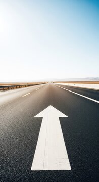 A scenic perspective of a long asphalt road stretching toward the horizon with a bold white arrow painted on the lane pointing forward, asphalt, bright, beginning