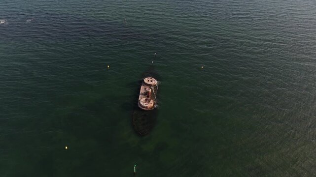 Aerial view tracking right over HMVS Cerberus historic shipwreck in ocean waters at Black Rock.