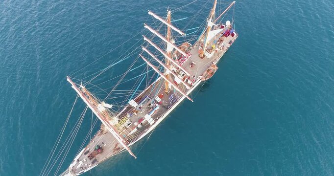 Aerial view of the Buque Escuela Simon Bolivar sailing ship navigating the turquoise waters of the Caribbean Sea in Los Roques, Dependencias Federales, Venezuela.