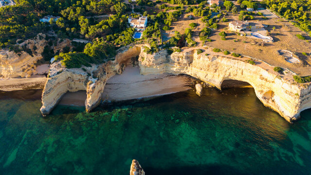 Aerial view of rocky coastal formations above turquoise sea in Portugal. Algarve. Beach 
