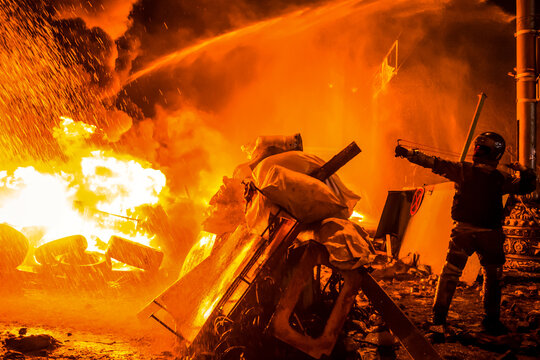 Civil revolution and protests on the city streets in fire. Street riots