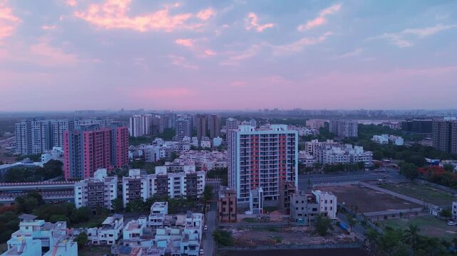 Aerial view of modern residential buildings and urban landscape during sunset in Surat, Gujarat, India.