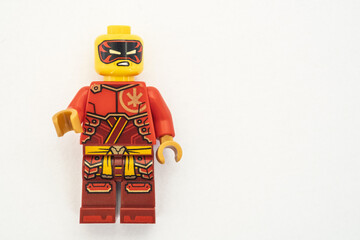 Obraz premium Kai lego mini figure from the Ninjago series, shot close-up and isolated on a white paper background. Seen here wearing a black and red mask. Bradford, UK.Sep 28 2026