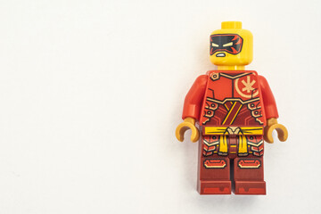 Obraz premium Kai lego mini figure from the Ninjago series, shot close-up and isolated on a white paper background. Seen here wearing a black and red mask. Bradford, UK.Sep 28 2026