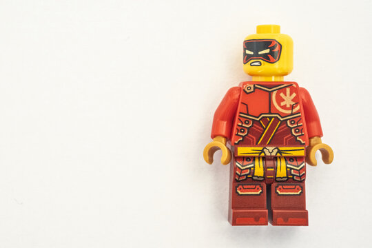 Kai lego mini figure from the Ninjago series, shot close-up and isolated on a white paper background. Seen here wearing a black and red mask. Bradford, UK.Sep 28 2026