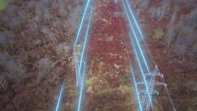 Aerial view of High voltage power lines and pylons with electricity flow. Smart grid energy transmission and electric infrastructure concept
