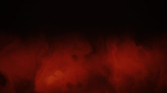 Dynamic fiery orange and red flames rising and swirling against a dark black background, representing intense heat and energy