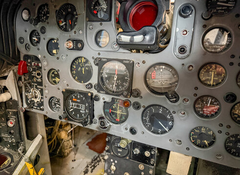 Detailed view of an old jet fighter cockpit with many dials and switches
