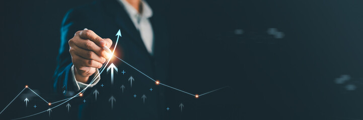 Professional businessman drawing a rising financial growth chart with upward arrows. Business success, stock market investment, profit growth, corporate strategy, banner copy space background