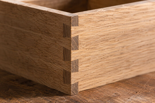 Close up of precise finger joint in a solid oak wooden box