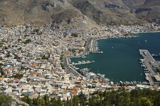 Coastal town with harbor and many boats, nestled in a mountain landscape, Pothia, main town, port, Kalymnos, sponge diving island, Dodecanese, Greek Islands, Greece