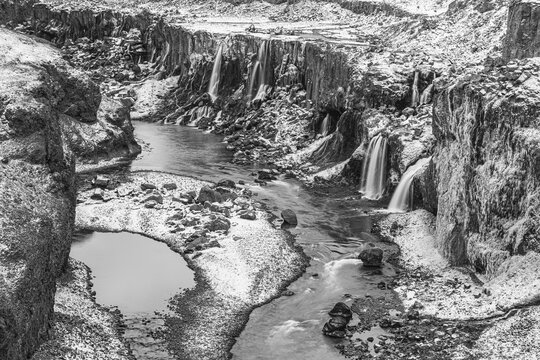 Hrauneyjarfoss waterfalls, onset of winter, black and white photo, Sudurland, Iceland