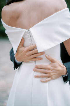Close up embrace of bride and groom at Nathan Phillips Square