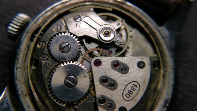 Macro footage of an authentic Swiss made vintage mechanical watch movement in operation, showing caliber number 1390 stamp, gears, ruby jewels, and spinning balance wheel.