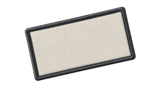 Close up of a blank rectangular woven fabric patch with a dark embroidered border, shown at an angle with visible textile texture and no printed design.