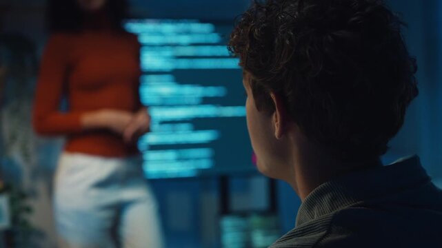 Diverse team software developer present coding on screen to colleague at office night. Mentor coach program leader, Creative startup teamwork discuss, Artificial intelligence system workshop concept.