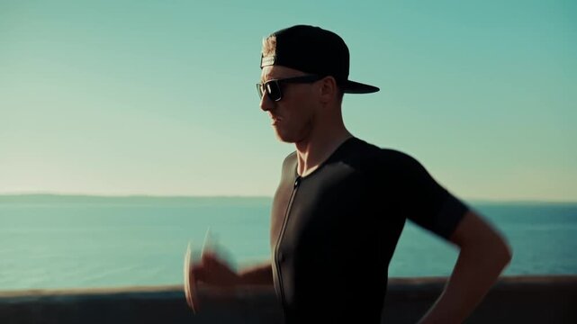 Runner Jogging Along Waterfront Promenade At Sunset. Outdoor Cardio Workout Training