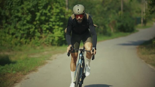 Cyclist Wearing Riding Road Bicycle Fast On Asphalt Highway. Sport Exercise Outdoor Training Workout