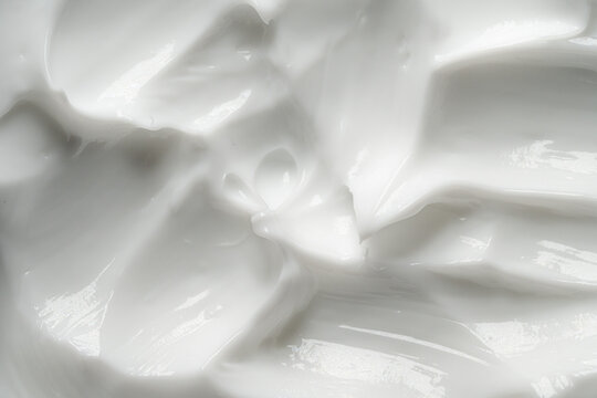 White cream texture with smooth glossy surface and soft folds for skincare cosmetics beauty products. 