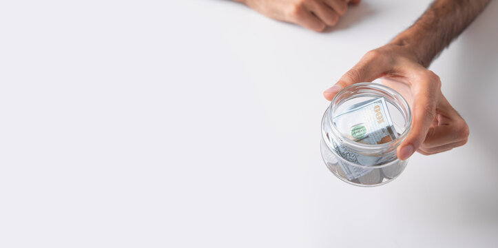 Man showing coin jar. Finance