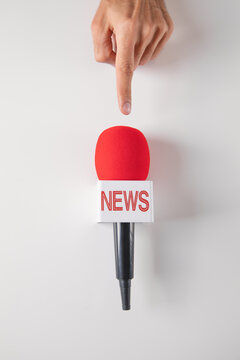 Journalist holding a microphone on a white background.