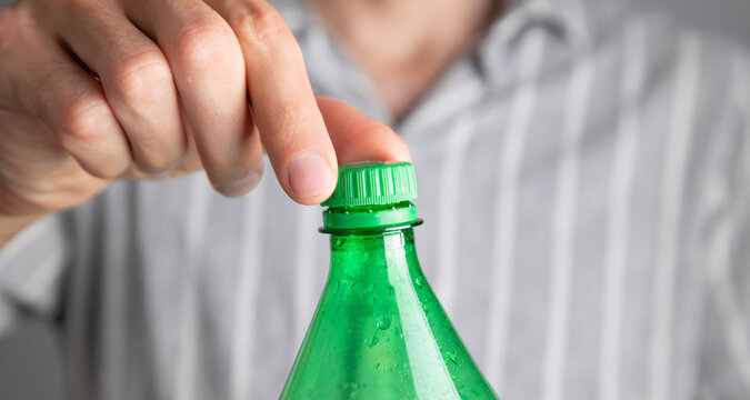 Man opening bottle of water. Close Up view