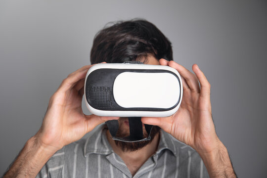 Caucasian man wearing virtual reality goggles.