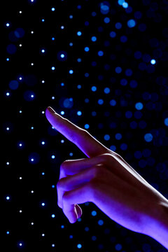 3D hand reaching into blue digital data field with futuristic technology particles