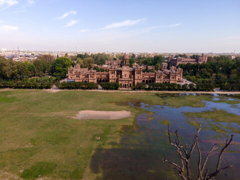 Aerial view of the historic Islamia College University Peshawar, featuring iconic red-brick architecture, lush gardens, and expansive grounds in Peshawar, Khyber Pakhtunkhwa, Pakistan.