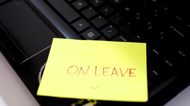 On leave, annual leave for an employee. An "ON LEAVE" sign sits above the keyboard, conveying the message at the workstation that the person is not currently working.
