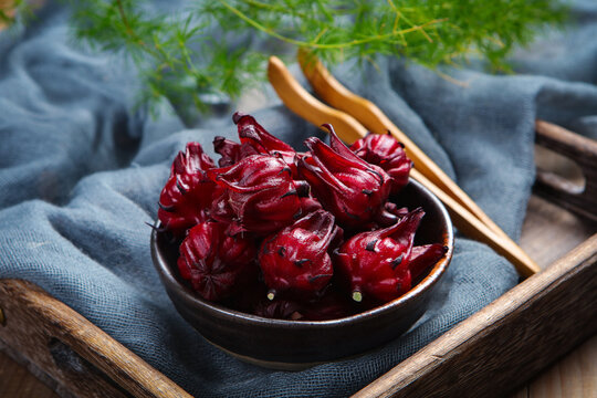 Fresh Roselle Hibiscus Flowers In Wooden Bowl For Herbal Tea