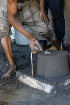 Close-up of hands finishing an aluminum pot, Ambatolampy, Madagascar